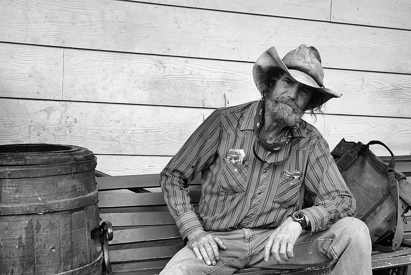 Bench.jpg :: Julian, California. Todays cowboy's are a vanishing breed of individuals hanging on as long as they can, looking for jobs that are now few and hard to find, This Gent has spent his entire life in a bunk house setting, he is lost, as his skills are set aside to technology and a diminishing industry.