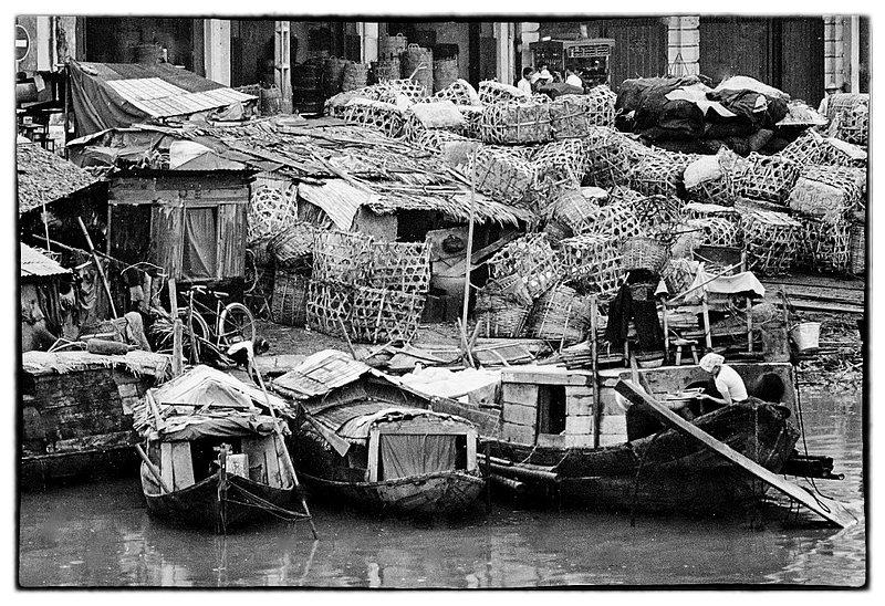 Boat Homes.jpg :: A goodly number of Vietnamese families live on the water spending the majority of their lives on boats that are clustered close together and used not only for homes but for their livelihood as well. 