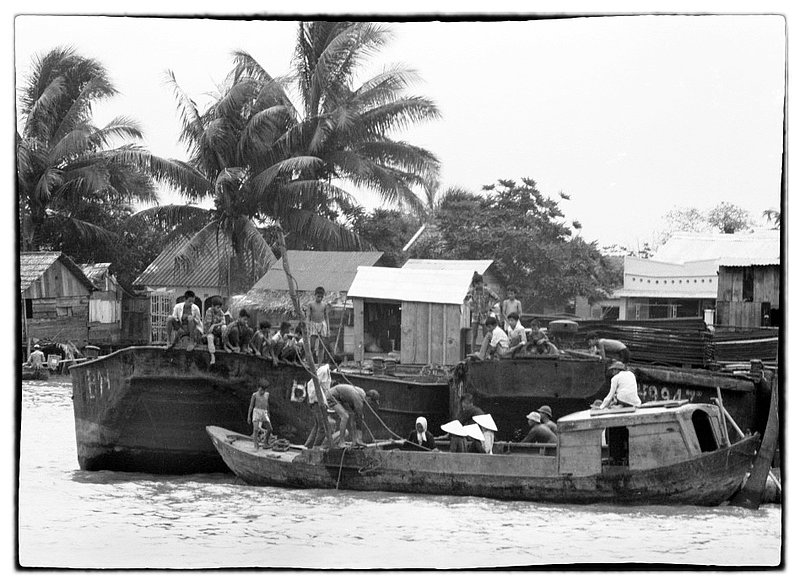 Boat villages.jpg :: Where there is water there are boats, the life on the waters provides food, and commerce for these families. Often times i view groups of boats linked together forming a makeshift like village. I imagine these gathering spots are centers for commerce.