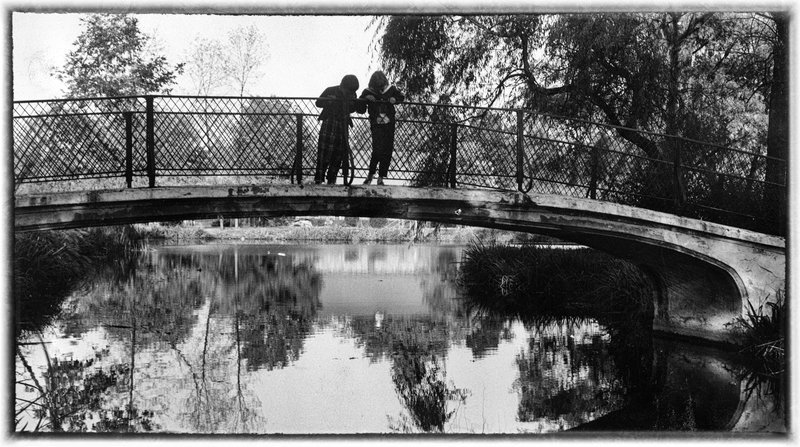Carefree Reflection.jpg :: Roaming in Lafayette, Indiana I  captured  three childhood friends gazing into a river from a bridge.