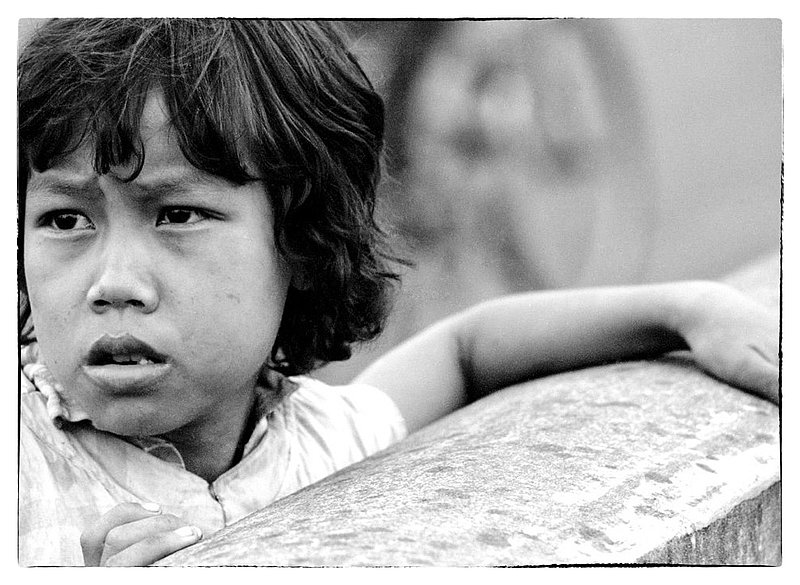 Child.jpg :: While filming around Long Binh, children appear, disapear and re appear day after day. Im sure that our Military folks pass candies and foodstuff to them as an act of kindness. Vietnamese civilians also work at the facility which also brings a new dimension to consider.