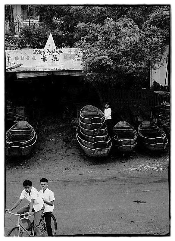 Commerce.jpg :: It seems that all ages of the Vietnamese people,  for the most part participate in contributing to help the family survive. This young lady tends to a boat rental enterprise.