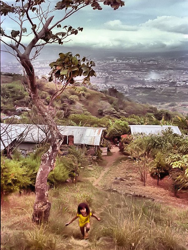 Costa Rica child.jpg :: Outside the city of San Jose in the coffee bean producing mountains, I captured an image of a little child  as she climbed the mountian path from her home. In the background is the city of San Jose