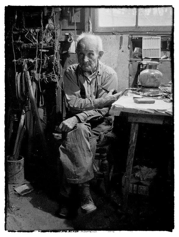 Lost in my thoughts.jpg :: As I watched him, i wondered how he could survive in this old weather beaten tar paper shack with a dirt floor and not much more. In the time we shared he never complained of his life. In a way he reminded me of my own Dad who has an old dirt cellar where he hoards artifacts of the past some of which are over one hundred years old and belonged to his Father. Us kids call him a pack rat. We also know that being in the cellar is a source of contentment for him.