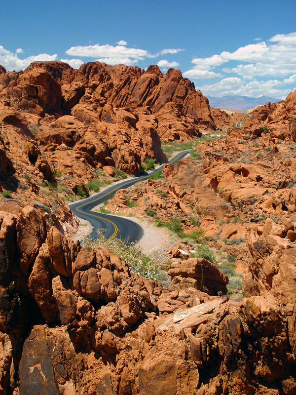 Nevada Valley of Fire.jpg :: 
 The Valley of Fire consists of bright red Aztec sandstone outcrops nestled in gray and tan limestone mountains. The sandstone is from the Jurassic period and is the remnant of the sand left behind by the wind after inland seas subsided and the land rose.