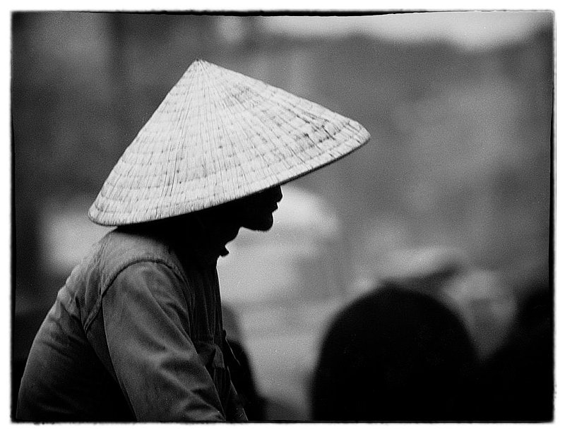 Non La (Hat).jpg :: Non La is a Vietnamese headwear used to shield the sun and the rain. This Conical style hat has been worn since ancient times and the hat symbolizes the people.  Some hats have inspirational writings or pomes written under the cone.