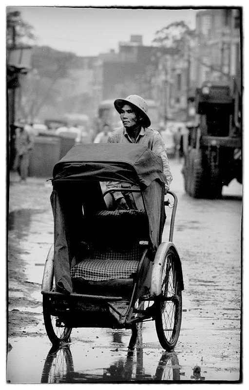 Rickshaw.jpg :: Rickshaws, Vietnamese taxi's are ever present in Saigon and throughout Vietnam, for a few Piastres one can ride in relative comfort in an enclosed or open ride somewhat escape from sudden Monsoon activity.