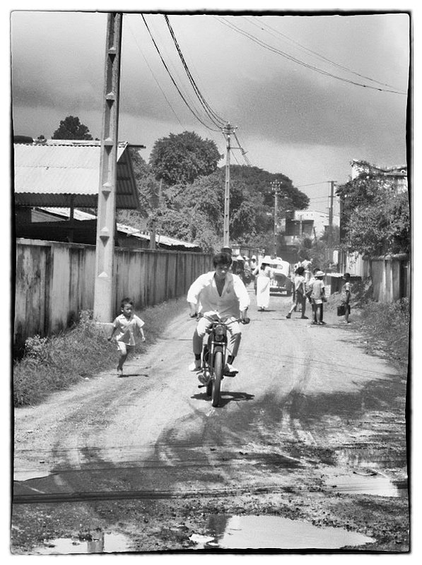 Rider.jpg :: Another street scene of a Vietnamese Bicyclist traversing a pot holed muddy monsoon damaged road