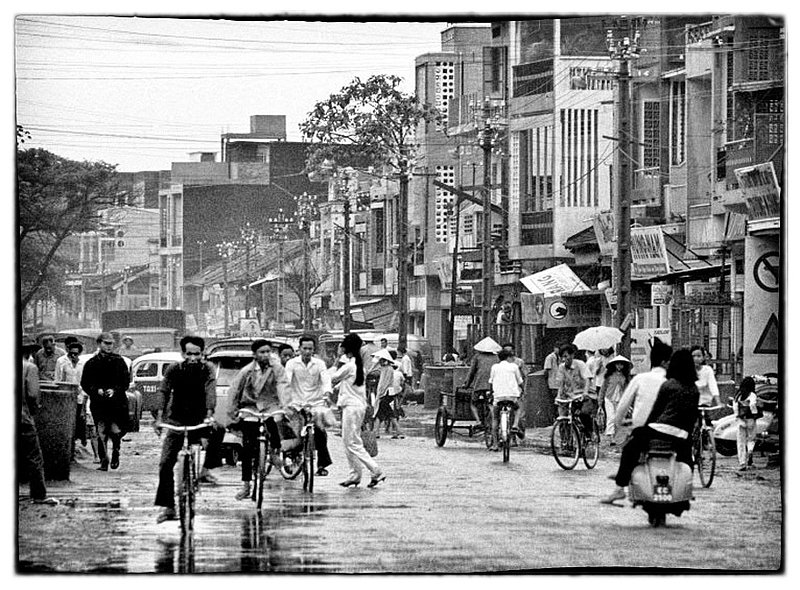 Saigon Streets.jpg :: The hustle and bustle on the streets of Saigon is a twenty four hour event, people of all walks of life trying to make a living and attending to their chores of the day. The city streets have a smell of garlic, and onions being cooked along with not so pleasant whiffs of gasoline and human waste. 