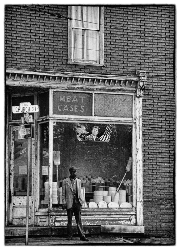 Saturday Morning.jpg :: Frederick, MD circa 1965
Early on a Saturday morning looking for a photo op and there it is on a corner staring me in the face. More than a picture of a man standing on a corner the window tells of a time when a nation was still morning a fallen President, and the word Vietnam was entering into our vocabulary.