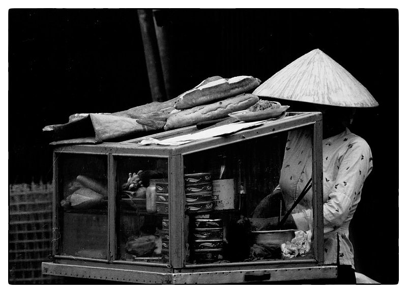 Street food banh mi.jpg :: Referred to as Howard Johnson's by the Anerican GIs, these carts are scattered every where throughout Vietnam, a popular stop for busy Vietnamese to enjoy a quick sandwich such as Bahn Mi a French Baquet filled with fresh vegetables, pickles and pork. 