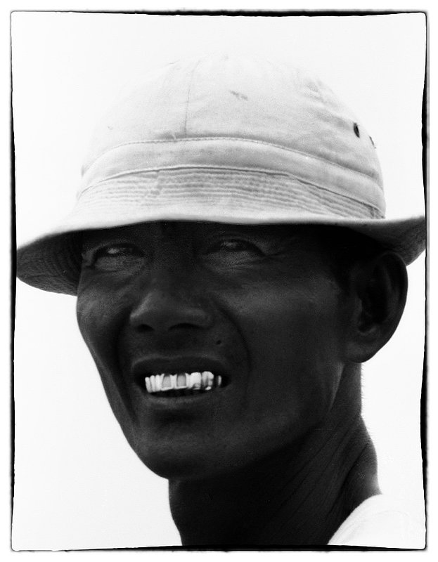 Sun beaten.jpg :: Captured this photo in the Delta of a sun beaten Vietnamese man with a mouthful of gold caps covering most of his teeth. 
