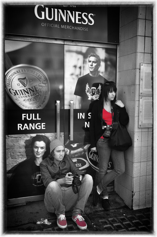 The Billboard.jpg :: In Gaelic there is a number of words for red, to include deargac  Strolling along the streets of Dublin this couple caught my eye as well as their juxtaposition to the billboard behind them. 