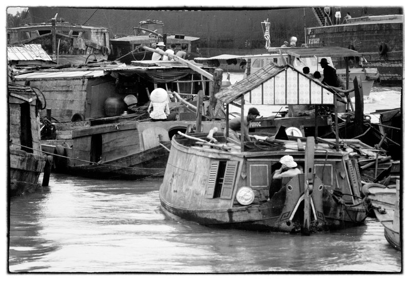 Water Home.jpg :: Water scene showing house boats and the toiling of busy Vietnamese people as they do day after day. Many of these people spend the majority of their tim in theses makeshift water boat homes.