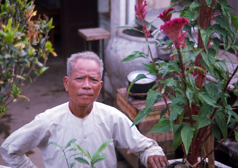 his home his garden his sanctuary.jpg :: Caught this image of an older Vietnamese man who lives along the tracks of the only active train in country as I was sitting on top of the two thousand bombs it was carrying North
