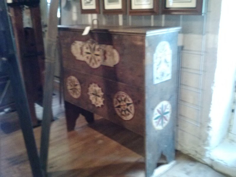 1028131357a.jpg :: Spectacular walnut grain bin, dated, hand planed, boot jack feet,  two incised compass designs, hand forged lift handle  and Sarah Gilligan folk art decoration.  $975.00
