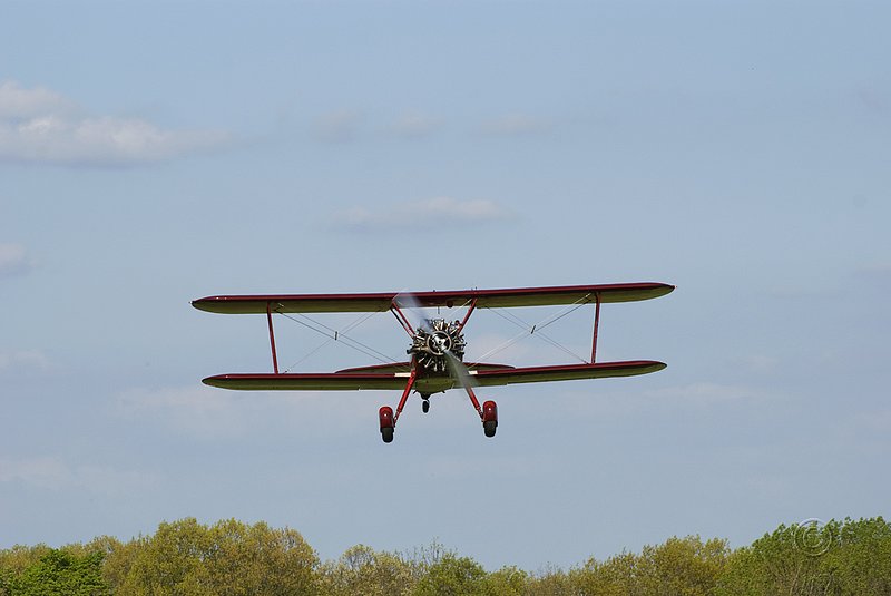 Red Biplane Taking Off.jpg :: Red Biplane Taking Off
