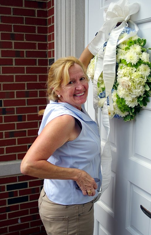Maggie hanging a wreath.jpg