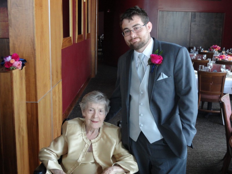 Matt with garden rose bouttonnierw poses with his grandmother.jpg
