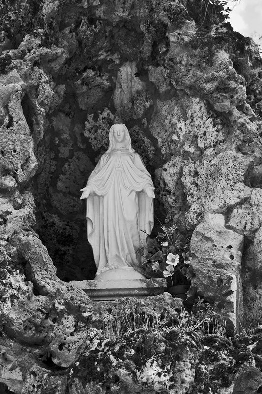 FRA_9755bw(1).jpg :: Statue of Our Lady of Lourdes in the Grotto in the grounds of Château de Sully in the Loire Valley, France