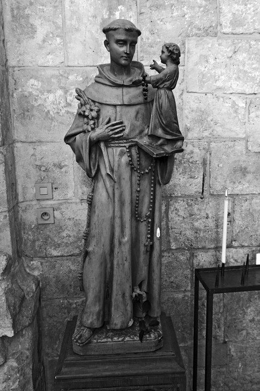 FRA_97752w(1).jpg :: Statue of a Monk Holding a Child in The Basilca of Fleury Abbey at Saint Benoir Sur Loire, France