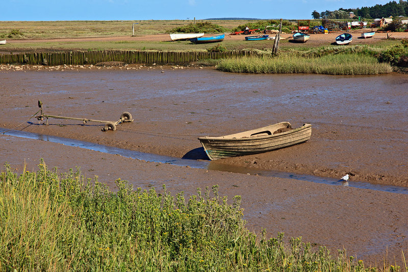 NFK20_069.jpg :: Old boat and trailer stuck in the mud at Brancaster Staithe, Norfolk, UK