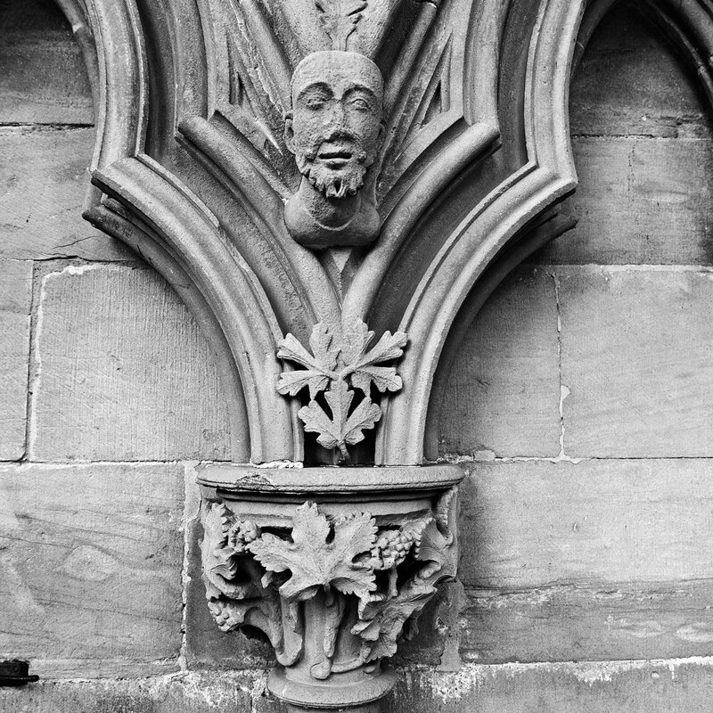 NSW19_0502w.jpg :: Close up of 13th century stone foliate capital and head carving in the Chapter House of Southwell Minster, Nottinghamshire