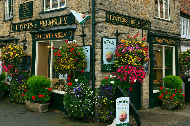 NYH_1809.jpg :: Colourful floral display on Delicatessen Shop in Helmsley North Yorkshire UK