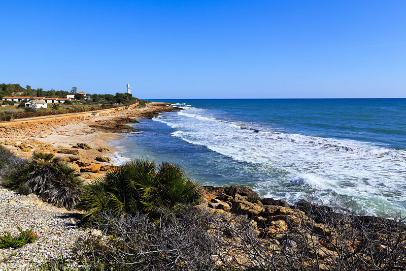 SPN_9422.jpg :: Bay and lighthouse at Cala Blanca Alcossebre Spain