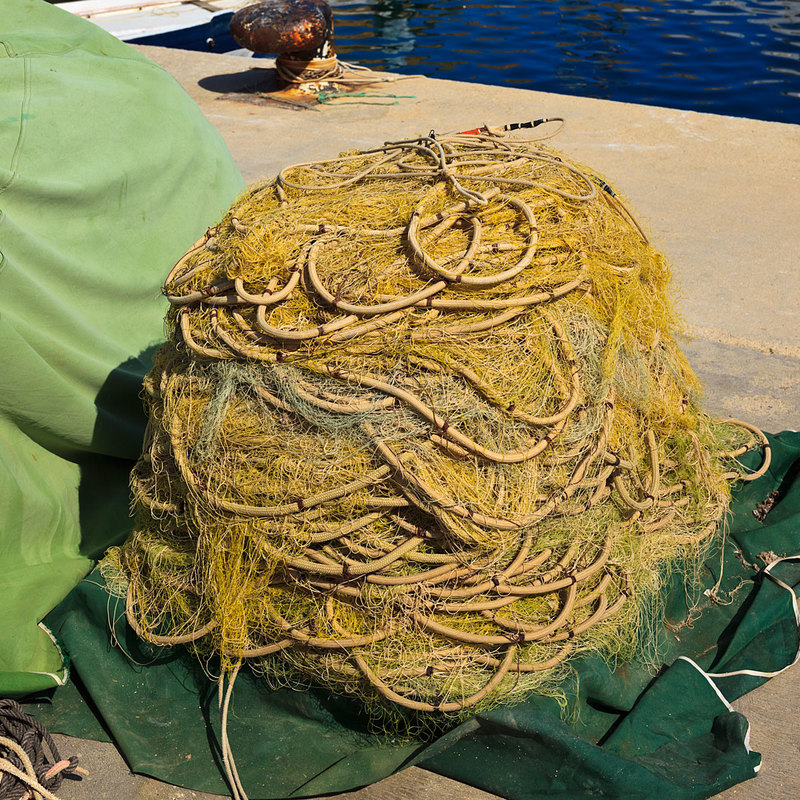 SPN19_390-1.jpg :: Fishermans nest coiled up on the quayside in Javea Port on the North Costa Blanca, Spain