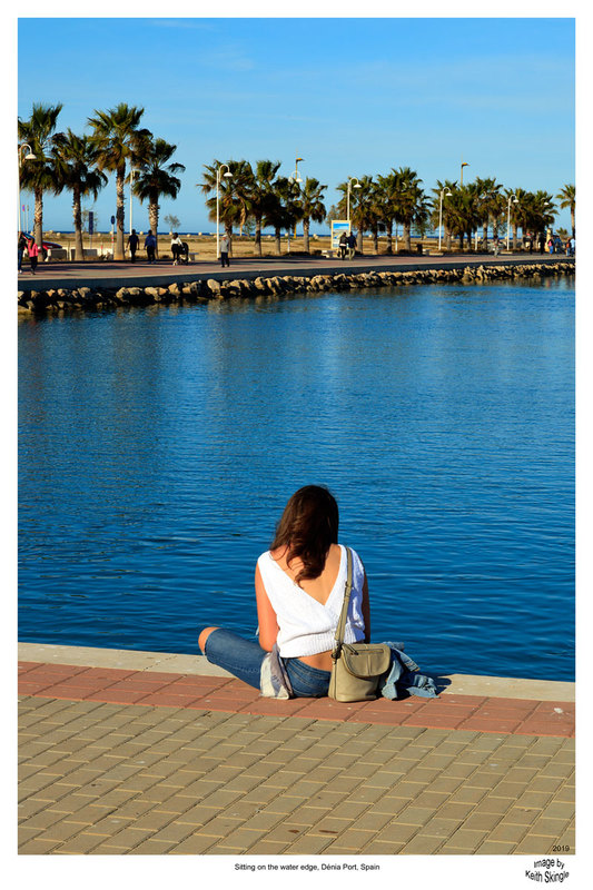 SPN19_451(1).jpg :: Young woman siiting by the water admiring the view in Dénia Port, Costa Blanca, Spain