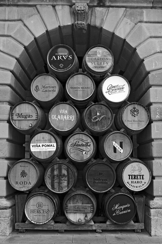 SPN19_5392.jpg :: Wine barrels from the Rioja wine producers of the region displayed in the arches of the Town Hall in Haro, La Rioja, Spain
