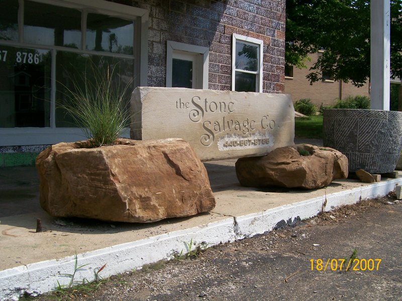 Reclaimed Curbstone Sign with the STONE SALVAGE Company etched in a slab in 2 pedestal planters.jpg :: Reclaimed Curbstone Sign with the STONE SALVAGE Company etched into a slab in sandstone pedestal planters