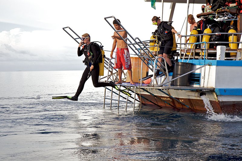 IMG_57941.jpg :: A diver takes a giant stride entry off a liveaboard into the Andaman Sea in the Similan Islands, Thailand.