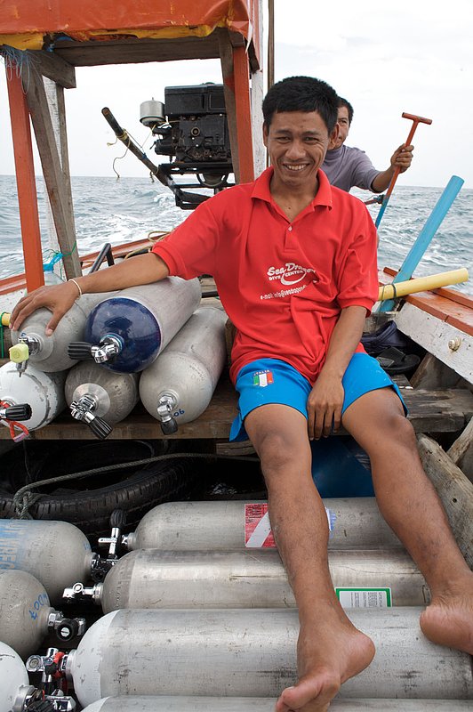 IMG_8545.jpg :: Thai boatman off of Khao Lak, Thailand working on a longtail used for scuba diving.