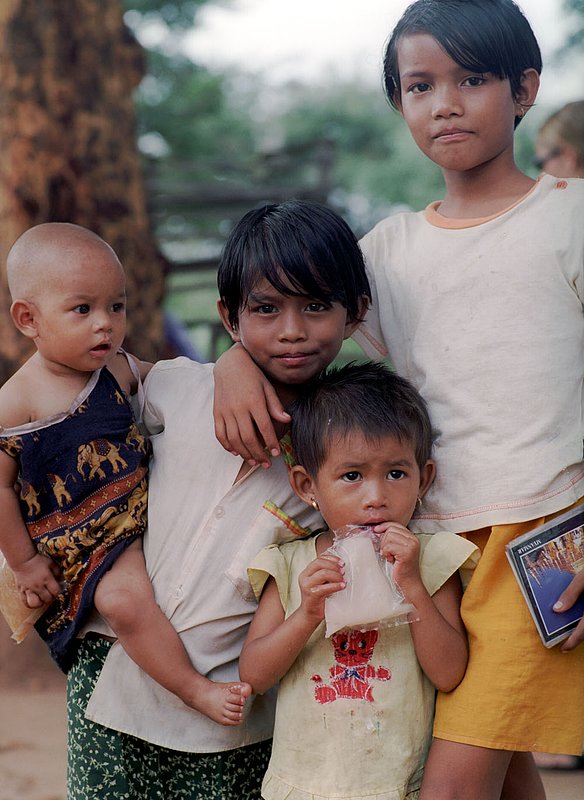 burmesechildren.jpg :: Young Burmese children selling postcards next to pagodas in Bagan, Myanmar.