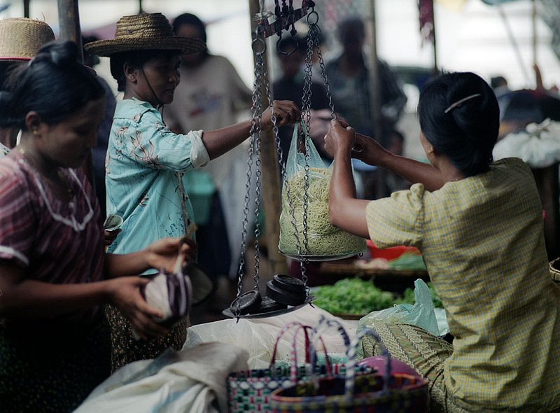 burmesescale.jpg :: Burmese women buying and selling noodles at a market in Bagan, Myanmar.