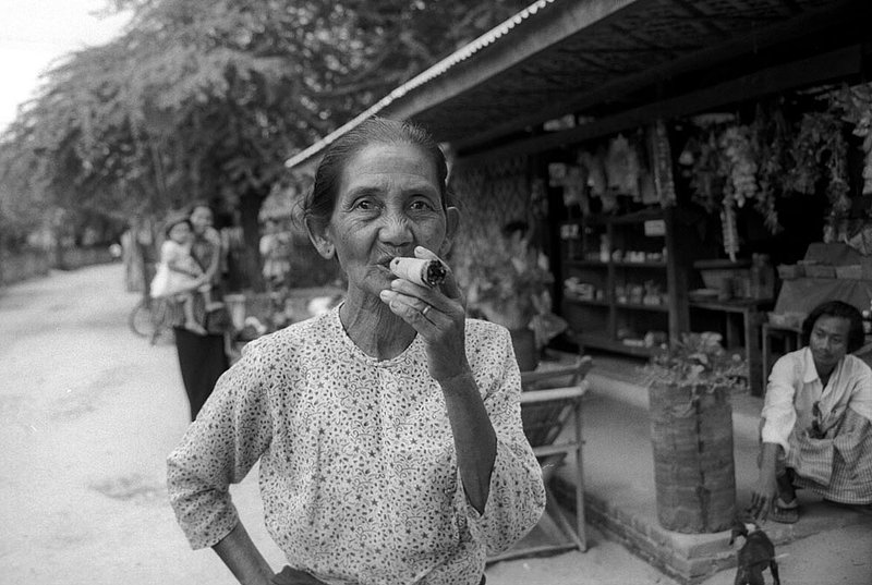 cigarwomanagain.jpg :: An elderly Burmese woman smoking a cigar that she just rolled in Bagan, Myanmar.
