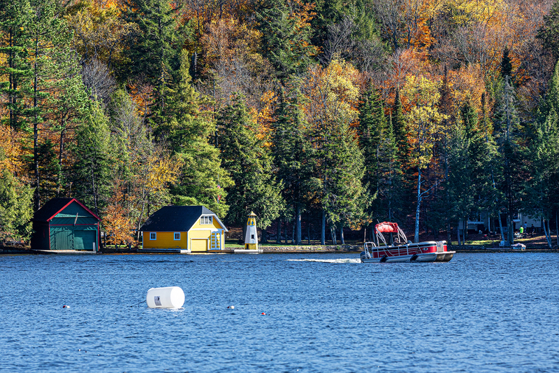 NY728.jpg :: A telephoto view of the iconic yellow boathouse & lighthouse on Old Forge Pond

Old Forge, NY - Fall 2019