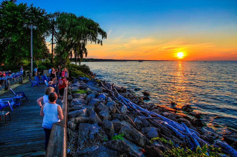 NY472.jpg :: Mid Summer sunset's guiding light to the Lake Ontario shoreline from the back deck of Castaways Restaurant

Webster NY - Summer 2016