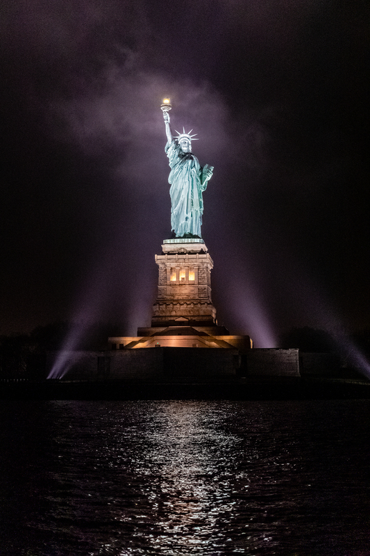 NY674c.jpg :: Dramatic view of the Statue Of Liberty on a foggy night

New York City, NY - Spring 2019