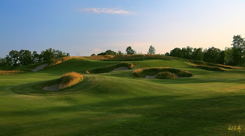 55  Erin Hills Erin WI -- 1552.jpg :: The tee shot landing area and green complex of the short par 4 fifteenth hole at Erin Hills.  Erin Hills is a daily fee golf course in Erin, Wisconsin.  It was designed by Hurdzan/Fry Designs and Ron Whitten and built by Landscapes Unlimited, LLC.  Photograph by Paul Hundley; July, 2011.