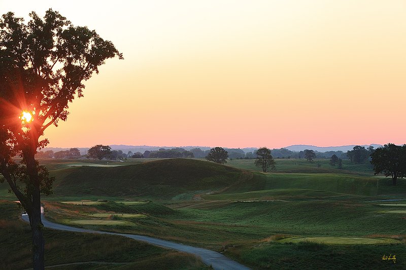 E101--0857  1200px with signature  V1  SS.jpg :: The par 4 (dogleg left around the hill in the center of the photo) eighth hole at Erin Hills.  Erin Hills is a daily fee golf course in Erin, Wisconsin.  It was designed by Hurdzan/Fry Designs and Ron Whitten and built by Landscapes Unlimited, LLC.  Photograph by Paul Hundley; July, 2011.