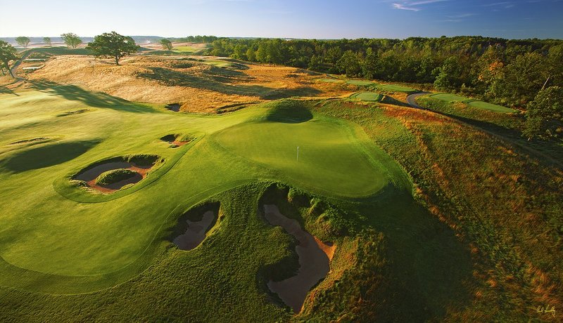 E101--1563  V1  1500px  SS - with signature.jpg :: The par four 15th green (foreground) and par 3 16th hole (above) with the par four 4th hole playing directly at the camera (top lrft center) at Erin Hills, a daily fee golf course in Erin, Wisconsin.  Erin Hills was designed by Hurdzan/Fry and Ron Whitten and built by Landscapes Unlimited, LLC, and has been choosen to host the 2011 US Amateur Chanpionship and the 2017 US Open Championship.  Photo by Paul Hundley; taken in July, 2012.