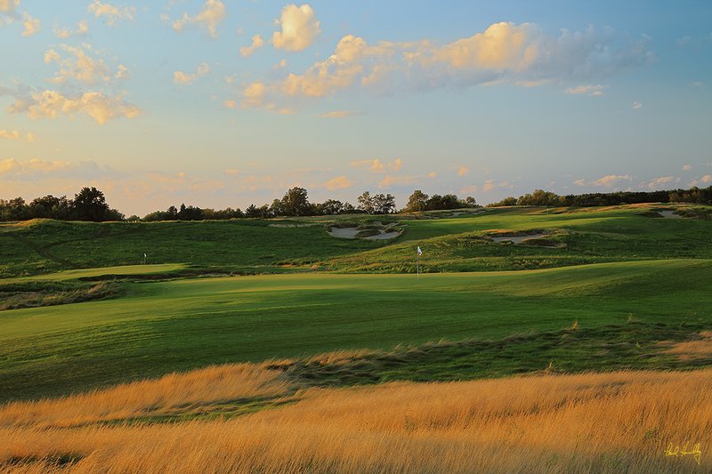 E101--1850  1200px  V1  SS.jpg :: 18th (center) green, 9th (left) green, and 10th (distant right) greens at Erin Hills; Erin, Wisconsin.  Erin Hills, a daily fee course, was designed by Hurdzan/Fry Designs and built by Landscapes Unlimited, LLC.; photo by Paul Hundley in August, 2010; PM shoot; print aspect ratio 0.65:1