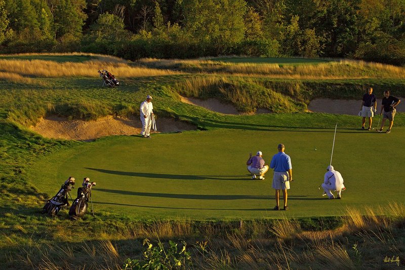 E101--Caddies-003  V1  1500px  SS - with signature.jpg :: Caddies and players at Erin Hills, a daily fee golf course in Erin, Wisconsin.  Erin Hills was designed by Hurdzan/Fry and Ron Whitten and built by Landscapes Unlimited, LLC, and has been choosen to host the 2011 US Amateur Chanpionship and the 2017 US Open Championship.  Photo by Paul Hundley; taken in September, 2012.