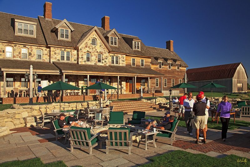 E101--Lodge 08  V1  1500px  SS - with signature.jpg :: Players relax and participate in a buffet spread after their round at Erin Hills, a daily fee golf course in Erin, Wisconsin.  Erin Hills was designed by Hurdzan/Fry and Ron Whitten and built by Landscapes Unlimited, LLC, and has been choosen to host the 2011 US Amateur Chanpionship and the 2017 US Open Championship.  Photo by Paul Hundley; taken in September, 2012.