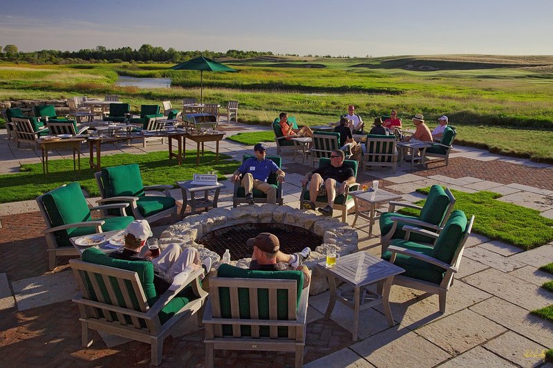 E101--Lodge 12  V1  1500px  SS - with signature.jpg :: Players relax and participate in a buffet spread after their round at Erin Hills, a daily fee golf course in Erin, Wisconsin.  Erin Hills was designed by Hurdzan/Fry and Ron Whitten and built by Landscapes Unlimited, LLC, and has been choosen to host the 2011 US Amateur Chanpionship and the 2017 US Open Championship.  Photo by Paul Hundley; taken in September, 2012.