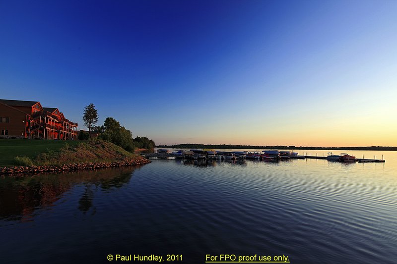FPO proof - N103--0051-05  12x18  aRGB 5DMk2-16  RAW.jpg :: One of the condominiums and the marina at Northern Bay Resort located in Arkdale, WIsconsin just before sunset.  Northern Bay Resort is also the home of The Castle Course, public golf course which is a mix of original holes and replicas of some of America's most famous golf holes.  June,  2011; PM shoot.  Photograph by Paul Hundley.