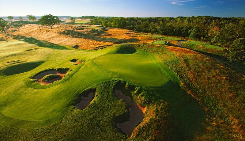 E101--1563  V1  1500px  SS - with signature1.jpg :: The par four 15th green (foreground) and par 3 16th hole (above) with the par four 4th hole playing directly at the camera (top lrft center) at Erin Hills, a daily fee golf course in Erin, Wisconsin.  Erin Hills was designed by Hurdzan/Fry and Ron Whitten and built by Landscapes Unlimited, LLC, and has been choosen to host the 2011 US Amateur Chanpionship and the 2017 US Open Championship.  Photo by Paul Hundley; taken in July, 2012.